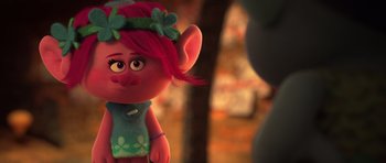 Movie still from “Trolls” (2016), directed by Mike Mitchell – A troll doll with a flower headband; Medium shot, Over the shoulder angle