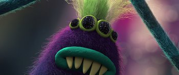 Movie still from “Trolls” (2016), directed by Mike Mitchell – A purple and green stuffed animal; Extreme Close Up shot, High angle