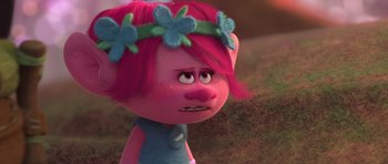 Movie still from “Trolls” (2016), directed by Mike Mitchell – A pink haired girl with a flower headband; Close Up shot, Over the shoulder angle