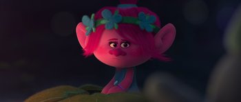 Movie still from “Trolls” (2016), directed by Mike Mitchell – A pink troll doll with a flower crown on it's head; Close Up shot, High angle