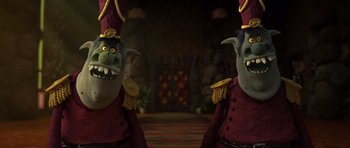 Movie still from “Trolls” (2016), directed by Mike Mitchell – A couple of people that are dressed up in costumes; Medium shot, Low angle