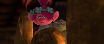 Movie still from “Trolls” (2016), directed by Mike Mitchell – A couple of trolls standing next to each other in the dark; Close Up shot, Over the shoulder angle