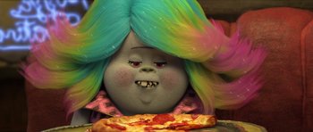 Movie still from “Trolls” (2016), directed by Mike Mitchell – A person with a colorful wig eating a piece of pizza; Close Up shot, Over the shoulder angle