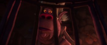 Movie still from “Trolls” (2016), directed by Mike Mitchell – A stuffed animal in a cage with a light shining on it's head; Close Up shot, Over the shoulder angle
