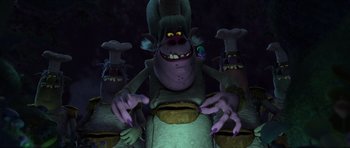 Movie still from “Trolls” (2016), directed by Mike Mitchell – A group of cartoon characters in a dark room; Medium shot, Low angle