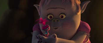 Movie still from “Trolls” (2016), directed by Mike Mitchell – A troll holding a troll doll in his hand; Close Up shot, Over the shoulder angle