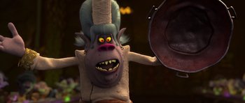 Movie still from “Trolls” (2016), directed by Mike Mitchell – A cartoon character with an evil look on his face; Medium shot, Over the shoulder angle