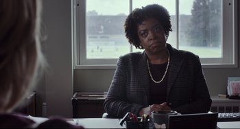 Movie still from “Tully” (2018), directed by Jason Reitman – A woman sitting at a table in front of a window; Close Up shot, Over the shoulder angle