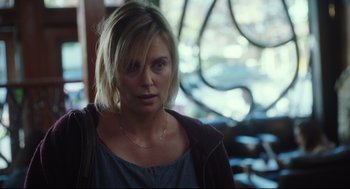 Movie still from “Tully” (2018), directed by Jason Reitman – A woman with blonde hair wearing a blue shirt; Close Up shot, Over the shoulder angle