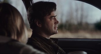 Movie still from “Tully” (2018), directed by Jason Reitman – A man sitting in the driver's seat of a car looking out the window; Close Up shot, Over the shoulder angle