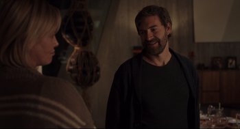 Movie still from “Tully” (2018), directed by Jason Reitman – A man with a goatee is talking to a woman; Medium shot, Over the shoulder angle