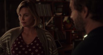 Movie still from “Tully” (2018), directed by Jason Reitman – Two people are talking in a room with a bookshelf in the background; Medium shot, Over the shoulder angle