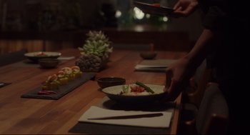 Movie still from “Tully” (2018), directed by Jason Reitman – A wooden table topped with a bowl of food; Extreme Close Up shot, High angle