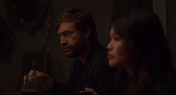 Movie still from “Tully” (2018), directed by Jason Reitman – A man and a woman sitting next to each other in a room; Medium shot, Over the shoulder angle