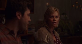Movie still from “Tully” (2018), directed by Jason Reitman – A woman and a man are talking in a room; Medium shot, Over the shoulder angle
