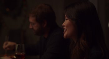 Movie still from “Tully” (2018), directed by Jason Reitman – Two people sitting in a dark room with one of them smiling; Close Up shot, Over the shoulder angle