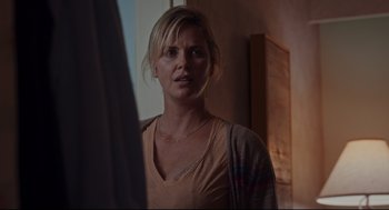Movie still from “Tully” (2018), directed by Jason Reitman – A woman standing in front of a mirror in a room; Close Up shot, Over the shoulder angle