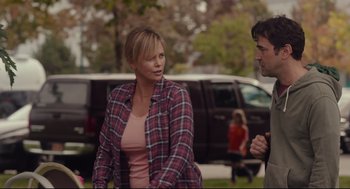 Movie still from “Tully” (2018), directed by Jason Reitman – A woman in a plaid shirt and a man in a pink shirt; Medium shot, Over the shoulder angle