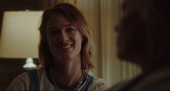 Movie still from “Tully” (2018), directed by Jason Reitman – A person smiling at the camera; Close Up shot, Over the shoulder angle