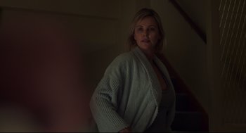 Movie still from “Tully” (2018), directed by Jason Reitman – A woman standing in a room with her hands on her hips; Medium shot, Over the shoulder angle