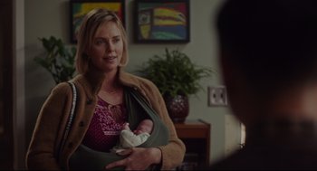 Movie still from “Tully” (2018), directed by Jason Reitman – A woman holding a baby in her arms; Medium shot, Over the shoulder angle