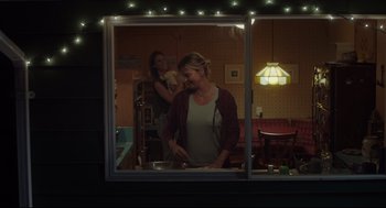 Movie still from “Tully” (2018), directed by Jason Reitman – Two women are standing in a kitchen looking out the window; Medium shot, Over the shoulder angle