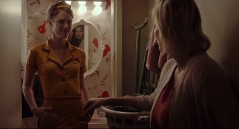 Movie still from “Tully” (2018), directed by Jason Reitman – Two women are talking to each other in front of a mirror; Medium shot, Over the shoulder angle