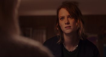 Movie still from “Tully” (2018), directed by Jason Reitman – A woman with long red hair is looking into the mirror; Close Up shot, Over the shoulder angle