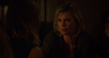Movie still from “Tully” (2018), directed by Jason Reitman – A woman sitting in front of another woman in a dark room; Close Up shot, Over the shoulder angle