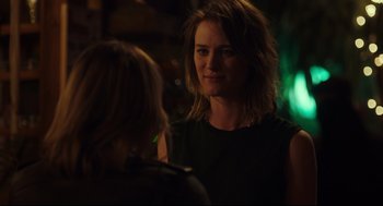 Movie still from “Tully” (2018), directed by Jason Reitman – A woman standing next to another woman in a dark room; Close Up shot, Over the shoulder angle