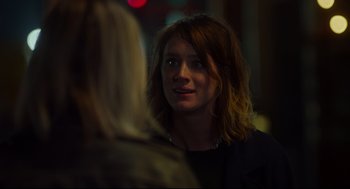 Movie still from “Tully” (2018), directed by Jason Reitman – A woman is looking at a woman in the dark; Close Up shot, Over the shoulder angle