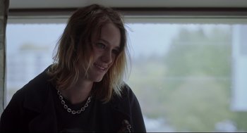 Movie still from “Tully” (2018), directed by Jason Reitman – A woman with long blonde hair wearing a black shirt; Close Up shot, Over the shoulder angle