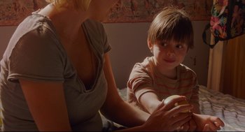 Movie still from “Tully” (2018), directed by Jason Reitman – A woman and a boy are sitting on a bed; Close Up shot, Over the shoulder angle