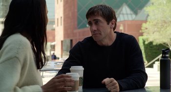 Movie still from “Velvet Buzzsaw” (2019), directed by Dan Gilroy – A man and a woman sitting at a table with a cup of coffee in front of them; Medium shot, Over the shoulder angle