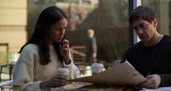 Movie still from “Velvet Buzzsaw” (2019), directed by Dan Gilroy – A woman sitting at a table with two cups of coffee; Medium shot, Over the shoulder angle