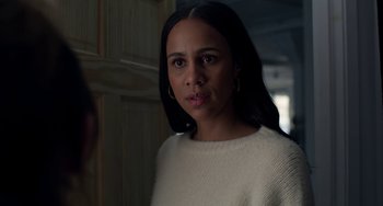 Movie still from “Velvet Buzzsaw” (2019), directed by Dan Gilroy – A woman in a white sweater is looking at the camera; Close Up shot, Over the shoulder angle