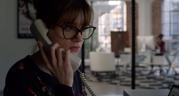 Movie still from “Velvet Buzzsaw” (2019), directed by Dan Gilroy – A woman talking on a phone while wearing glasses; Close Up shot, Low angle