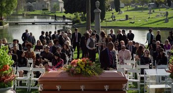 Movie still from “Velvet Buzzsaw” (2019), directed by Dan Gilroy – A crowd of people standing around a casket in a cemetery; Wide shot, High angle