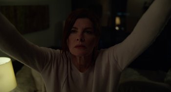 Movie still from “Velvet Buzzsaw” (2019), directed by Dan Gilroy – A woman with her arms raised in the dark; Medium shot, Low angle