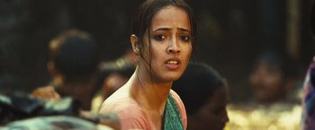 Movie still from “Slumdog Millionaire” (2008), directed by Danny Boyle – A young woman is looking into the camera; Close Up shot, Low angle