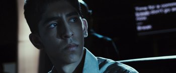 Movie still from “Slumdog Millionaire” (2008), directed by Danny Boyle – A young man is sitting in a car at night; Close Up shot, Low angle