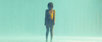 Movie still from “Slumdog Millionaire” (2008), directed by Danny Boyle – A girl standing in the water with her hands on her hips; Wide shot, Low angle
