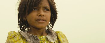 Movie still from “Slumdog Millionaire” (2008), directed by Danny Boyle – A person wearing a yellow dress; Close Up shot, Low angle