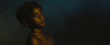 Movie still from “Slumdog Millionaire” (2008), directed by Danny Boyle – A young girl is looking up at the sky at night; Close Up shot, High angle