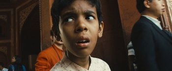 Movie still from “Slumdog Millionaire” (2008), directed by Danny Boyle – A young boy looking up at the sky; Close Up shot, High angle