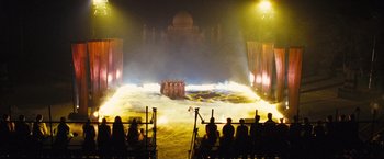 Movie still from “Slumdog Millionaire” (2008), directed by Danny Boyle – A group of people standing in front of a stage; Extreme Wide shot, High angle