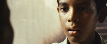 Movie still from “Slumdog Millionaire” (2008), directed by Danny Boyle – A young man's face; Close Up shot, Low angle