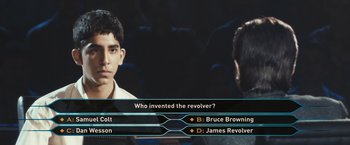 Movie still from “Slumdog Millionaire” (2008), directed by Danny Boyle – A man and a woman are playing a video game together; Close Up shot, High angle