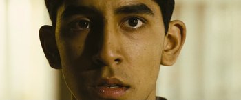 Movie still from “Slumdog Millionaire” (2008), directed by Danny Boyle – A young man's eyes and face; Close Up shot, Low angle