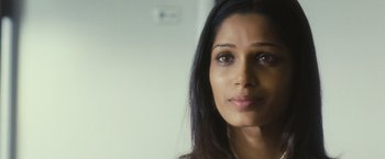 Movie still from “Slumdog Millionaire” (2008), directed by Danny Boyle – A woman's face in a white room; Close Up shot, Over the shoulder angle